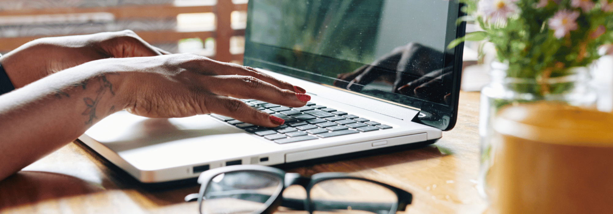 Hands typing on a computer